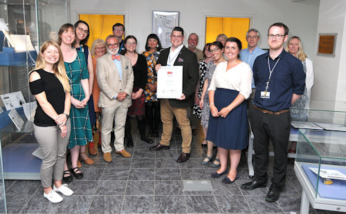Staff photo with accreditation certificate